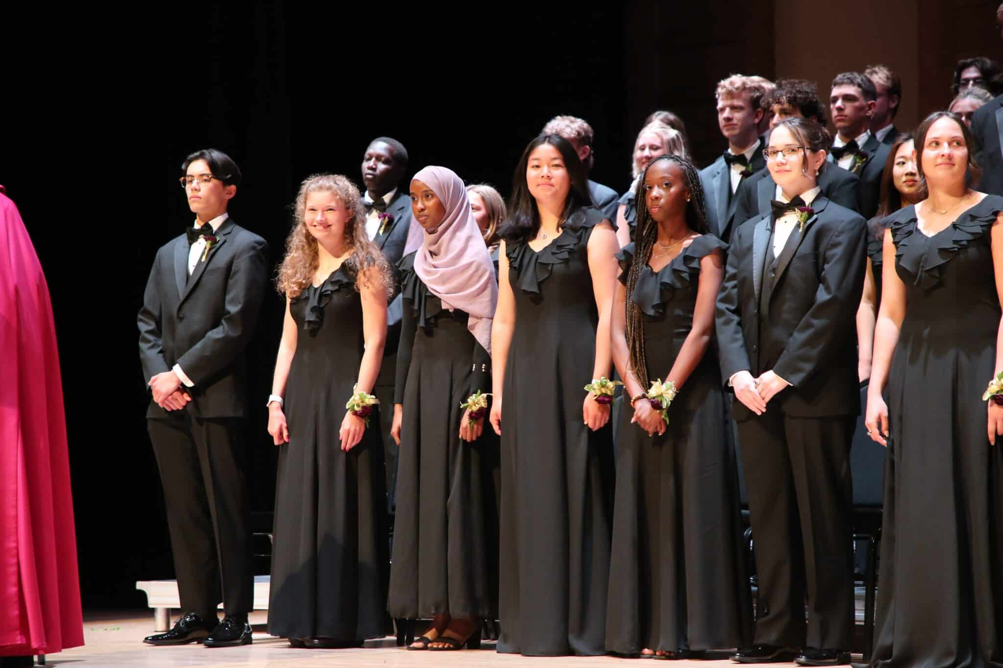 students dressed up at concert wearing black dresses